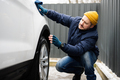 Man wipes american SUV car with a microfiber cloth after washing in cold weather. - PhotoDune Item for Sale