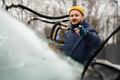 Man wipes american SUV car windshield with a microfiber cloth after washing in cold weather. - PhotoDune Item for Sale