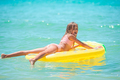 Little happy girl with inflatable air mattress in the sea having fun  - PhotoDune Item for Sale