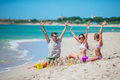 Family enjoying time on the beach making sand castle together on the seashore - PhotoDune Item for Sale