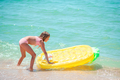 Little happy girl with inflatable air mattress in the sea having fun  - PhotoDune Item for Sale