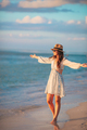 Young happy woman on the beach enjoy her summer vacation. Beautiful woman in hat is happy and calm - PhotoDune Item for Sale