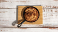 Cinnamon bun in black metal pan on the wooden table - PhotoDune Item for Sale