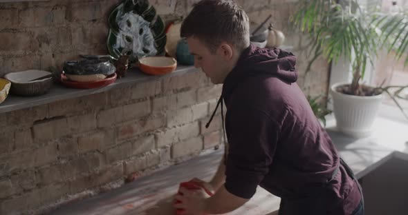 Potter Kneads Clay with Dye in Slow Motion Pottery at Workshop Potter Prepares Clay for Making