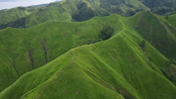 Aerial View of Tropical Blue Ocean Bay and Green Hills