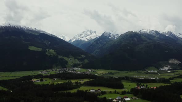 Panoramic View of a Picturesque Mountain Valley with a Village in a Lowland