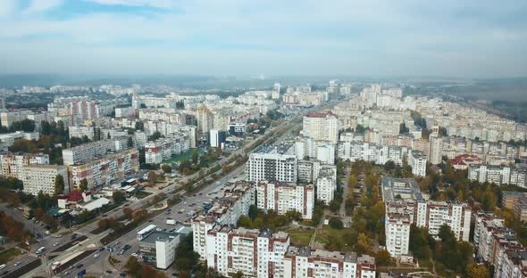 Aerial drone footage of city from above during autumn in a cloudy day.