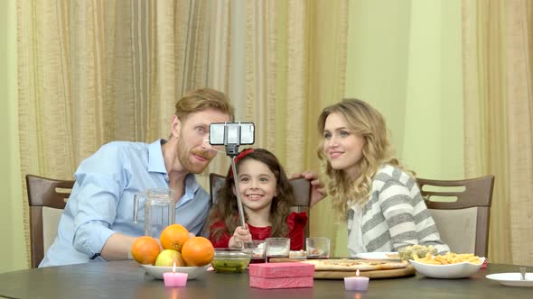 Family Taking Selfie During Dinner