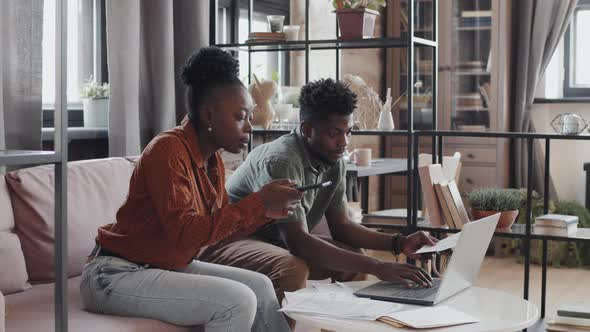 Couple Doing Paperwork in Living Room