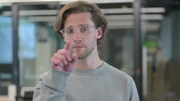 Portrait of Young Businessman Pointing at Camera