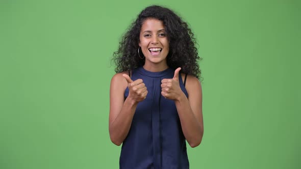 Young Beautiful Hispanic Businesswoman Giving Thumbs Up