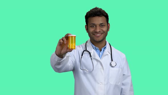 Smiling Doctor Showing Pills and Thumb Up