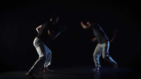 Two Men Are Performing Martial Art of Capoeira.