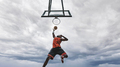 Street basketball player making a powerful slam dunk on the court  - PhotoDune Item for Sale