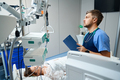 Doctor examining a patient in intensive care - PhotoDune Item for Sale