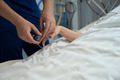 Lady lying in intensive care, nurse measuring pulse - PhotoDune Item for Sale