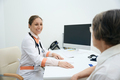 Cheerful therapist leads a reception in a medical clinic - PhotoDune Item for Sale