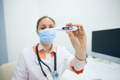 Woman medical worker holds a medical thermometer in her hands - PhotoDune Item for Sale
