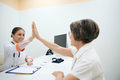 Therapist welcomes an elderly patient in the clinic - PhotoDune Item for Sale