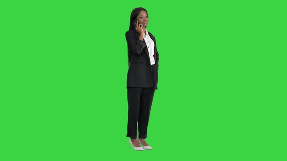 Casual African American Businesswoman Talking on Phone on a Green Screen, Chroma Key.