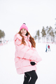 Young red haired woman in pink sportswear on winter snowy background - PhotoDune Item for Sale