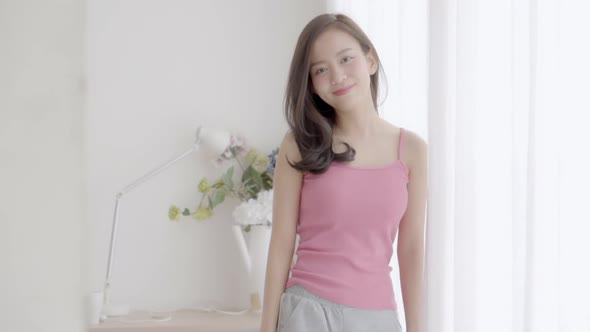 Portrait young asian woman with smiling and laughing in bedroom.