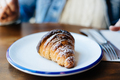 Close up of delicious fresh croissant on plate - PhotoDune Item for Sale