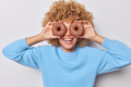 Cheerful woman covers eyes with delicious chocolates doughnuts smiles broadly shows white teeth has - PhotoDune Item for Sale