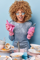 Irritated annoyed curly haired woman wears silver dress and protective rubber gloves applies - PhotoDune Item for Sale