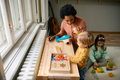 Happy black teacher and small boy playing with puzzle shapes at kindergarten. - PhotoDune Item for Sale