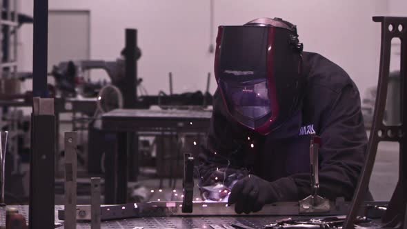 Super Slow Motion of Working Welder in Workshop