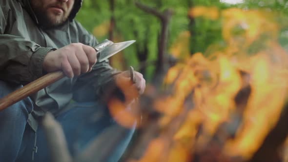 Slow Motion Of Casual Strong Man Works with Ax and Wood Near Warm Bonfire in Camp in Wild Deciduous