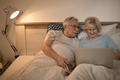 Senior couple resting in bedroom at night. - PhotoDune Item for Sale