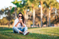 Young woman using mobile phone outdoor in the park - PhotoDune Item for Sale