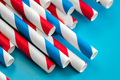 Drinking straws for party on blue background, close up. - PhotoDune Item for Sale