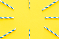 Party drinking straws arranged into a circle on yellow background. - PhotoDune Item for Sale