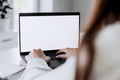 Woman hands typing on the laptop with blank white screen mockup laying on table - PhotoDune Item for Sale