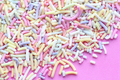 Pastel sprinkles on a pink background - PhotoDune Item for Sale
