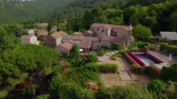 Approaching rustic villa in Branoux-les-Taillades Southern France with empty pool area for remodelin