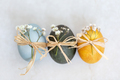 Three colored Easter eggs with spring flowers, closeup - PhotoDune Item for Sale