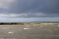 North Sea with wooden poles in a cloudy and windy day at Breskens - PhotoDune Item for Sale
