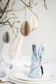 Easter tablescaping with bunny ear napkins and paper eggs. - PhotoDune Item for Sale