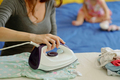 Woman Ironing Tidy Baby Clothes - PhotoDune Item for Sale
