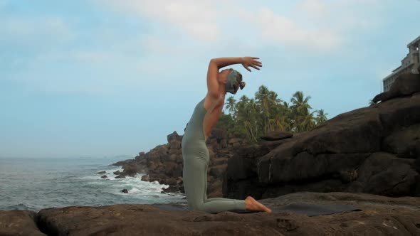 Girl Gets Into Kapotasana Pose on Flat Stone Slow Motion