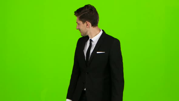 Man in a Suit Walks Along the Street, Looks Around. Green Screen