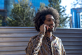 Young afro man using cellphone outdoor - PhotoDune Item for Sale