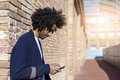 Young afro man using cellphone outdoor - PhotoDune Item for Sale