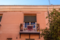 Traditional iron balcony with pots hanging from the railing - PhotoDune Item for Sale