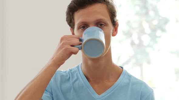Portrait of Man Drinking Coffee, Taking a Sip