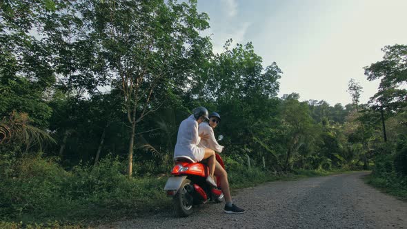 Love Couple on Red Motorbike in White Clothes to Go on Forest Road Trail Trip